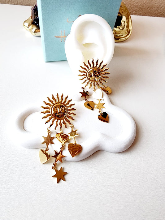 Sun earrings, Gold celestial earrings, Sun and star jewelry, Boho statement earrings,
Unique sun earrings, Sunburst earrings, Celestial jewelry, Star and heart earrings,
Bohemian jewelry style, Gold sun earrings, Dangling celestial earrings, Statement earrings for women, Sun and moon earrings, Vintage-inspired earrings, Spiritual jewelry,
Sun charm earrings, Astrology-inspired jewelry, Durable earrings, Elegant earrings, Timeless design, aesthetic earrings, timeless earrings, Fashion accessories, Stylish je