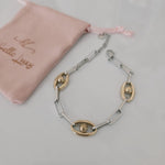 Meet your new everyday statement. This two-tone bracelet blends sleek silver links with rich gold accents, creating the perfect balance of bold and timeless. Its modern chain design makes it versatile enough for daily wear yet striking enough to elevate any outfit.

Crafted in durable stainless steel, this piece is water-resistant, hypoallergenic, and made to keep its shine — no fading, no tarnishing, just effortless glow. Wear it solo for a clean, elegant look or stack it with your favorite bangles for tha