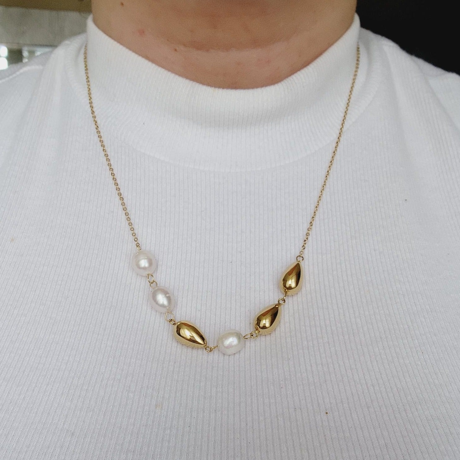 Pearls Gold Necklace, minimalist charm, delicate, simplicity, elegance, understated beauty, dainty pendant, baroque pearls necklace, water-resistant, high-quality, tarnish-resistant, gold-plated stainless steel, longevity, durability, sleek design, versatile, day to night, casual, formal, must-have accessory, water-resistant, radiant, untarnished, exquisite, thoughtful gift, minimalist beauty.