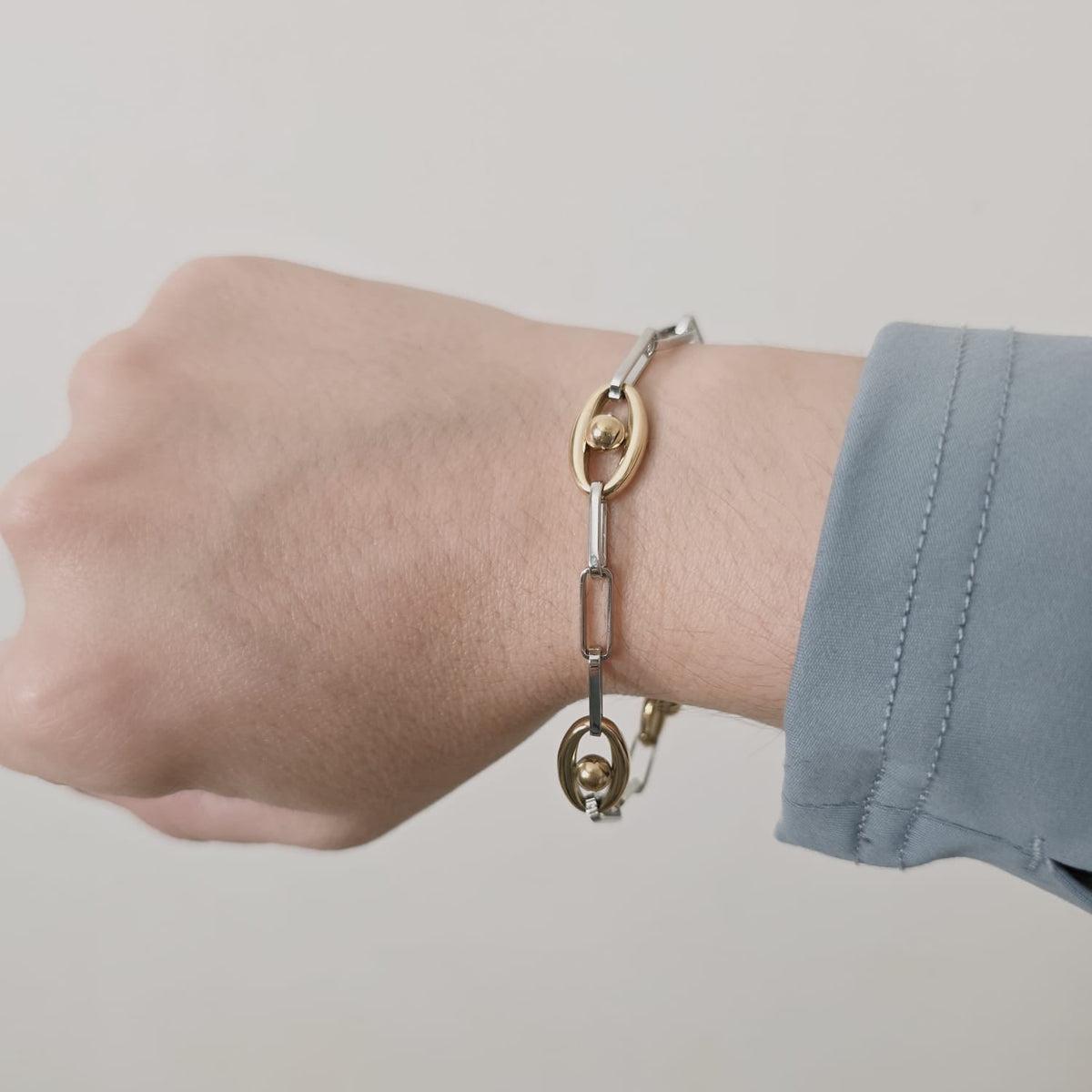 Meet your new everyday statement. This two-tone bracelet blends sleek silver links with rich gold accents, creating the perfect balance of bold and timeless. Its modern chain design makes it versatile enough for daily wear yet striking enough to elevate any outfit.

Crafted in durable stainless steel, this piece is water-resistant, hypoallergenic, and made to keep its shine — no fading, no tarnishing, just effortless glow. Wear it solo for a clean, elegant look or stack it with your favorite bangles for tha