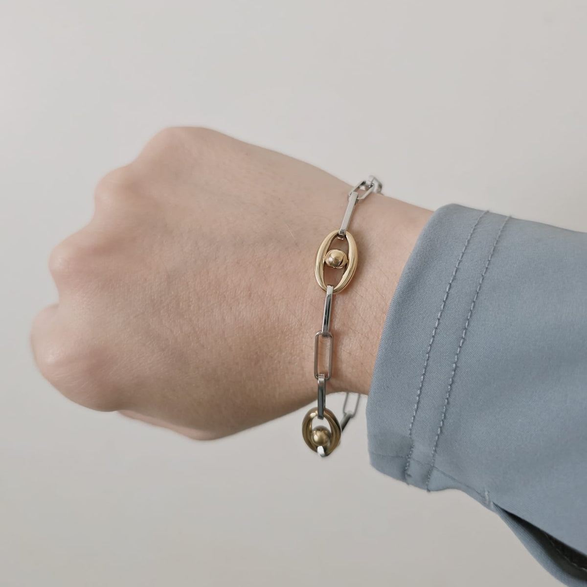 Meet your new everyday statement. This two-tone bracelet blends sleek silver links with rich gold accents, creating the perfect balance of bold and timeless. Its modern chain design makes it versatile enough for daily wear yet striking enough to elevate any outfit.

Crafted in durable stainless steel, this piece is water-resistant, hypoallergenic, and made to keep its shine — no fading, no tarnishing, just effortless glow. Wear it solo for a clean, elegant look or stack it with your favorite bangles for tha